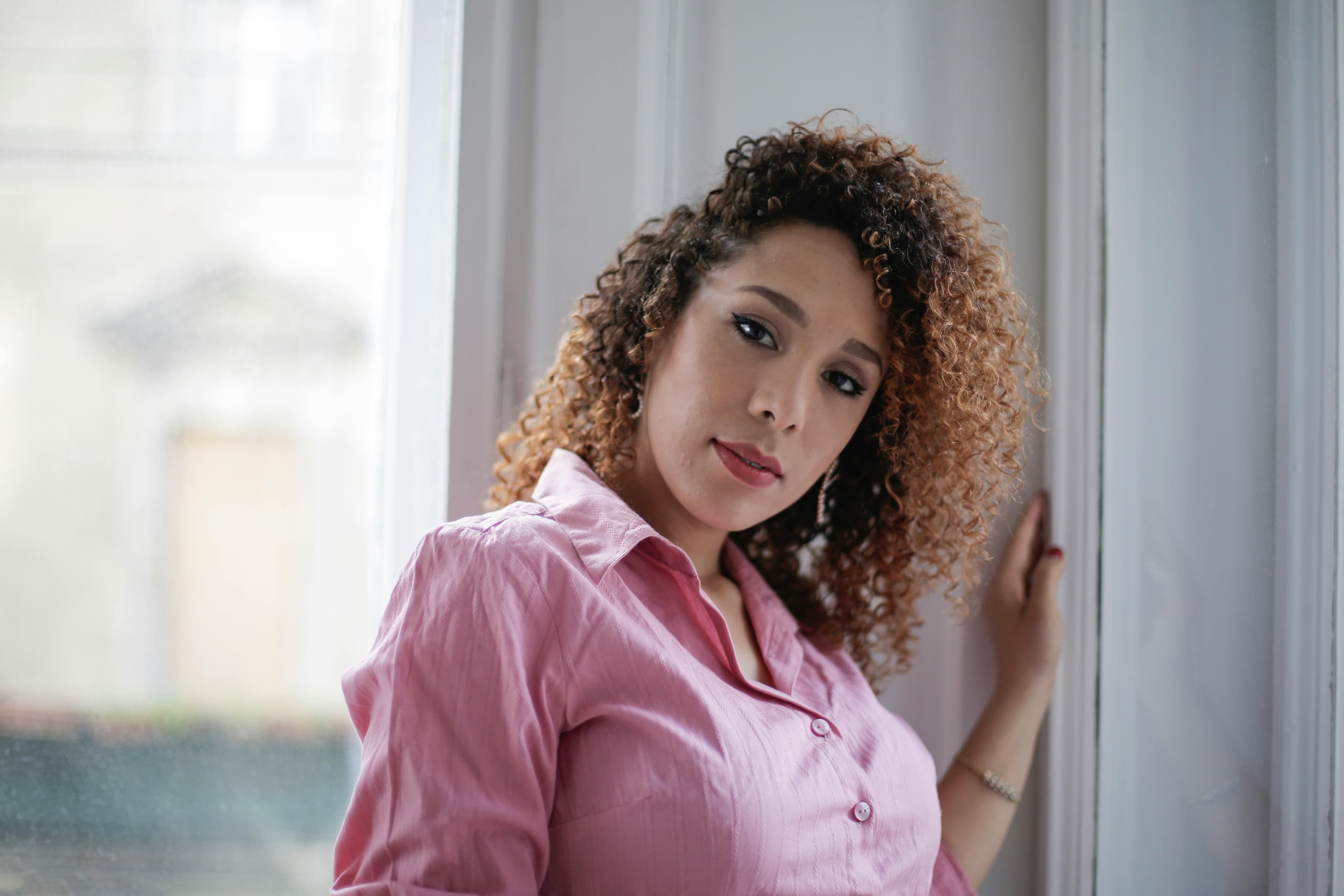 Latin woman with curly hair in room Latin woman with curly hair in room